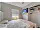 Comfortable bedroom featuring a ceiling fan and a wall-mounted TV at 551 Lindley Ter, Port Charlotte, FL 33952