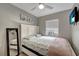 Bright bedroom with neutral walls, a comfortable queen-sized bed, ceiling fan, and serene decor for a cozy retreat at 551 Lindley Ter, Port Charlotte, FL 33952
