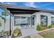Inviting front porch with seating, large windows, and well-maintained landscaping, perfect for enjoying outdoor living at 551 Lindley Ter, Port Charlotte, FL 33952