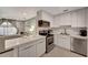 Modern kitchen with sleek cabinetry, stainless steel appliances, and a convenient breakfast bar with seating at 551 Lindley Ter, Port Charlotte, FL 33952