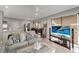 Comfortable living room with large windows, cozy seating, and an open layout to the dining and kitchen areas at 551 Lindley Ter, Port Charlotte, FL 33952