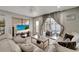 Inviting living room with comfortable sofas, a large TV, and seamless flow to the cozy sunroom at 551 Lindley Ter, Port Charlotte, FL 33952