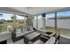 Relaxing sunroom with wicker furniture, large windows offering lots of natural light, and serene outdoor views at 551 Lindley Ter, Port Charlotte, FL 33952