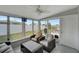Bright sunroom featuring wicker seating, ample light, and views of the backyard, perfect for lounging at 551 Lindley Ter, Port Charlotte, FL 33952