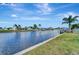 Waterfront view showcasing a canal with boat docks, lush landscaping, and clear blue water for scenic tranquility at 551 Lindley Ter, Port Charlotte, FL 33952
