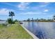 Scenic waterfront view highlighting a tranquil canal, lush green landscape, and clear blue skies for picturesque living at 551 Lindley Ter, Port Charlotte, FL 33952