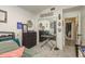 Bedroom with a mirrored closet, dresser, keyboard and patterned rug, leading to a view into an adjacent room at 5826 Taywood Dr, Tampa, FL 33624