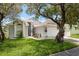 Inviting single-story home showcasing a lush front lawn and decorative landscaping near the entrance at 5826 Taywood Dr, Tampa, FL 33624