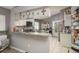 Eat-in kitchen featuring white cabinets, granite countertops, and a breakfast area with a glass table at 5826 Taywood Dr, Tampa, FL 33624