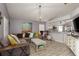Open living space connecting to the kitchen, featuring a comfortable gray sectional sofa and decorative accents at 5826 Taywood Dr, Tampa, FL 33624
