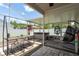 Enclosed patio with an outdoor dining table, a hot tub, and a hanging chair for relaxation and entertainment at 5826 Taywood Dr, Tampa, FL 33624
