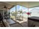A screened porch features outdoor dining, lounge seating, and a hot tub for relaxation at 5826 Taywood Dr, Tampa, FL 33624