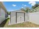A metal shed on a concrete foundation provides additional outdoor storage at 5826 Taywood Dr, Tampa, FL 33624