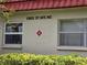 Well-maintained condo exterior with visible address and manicured landscaping enhancing curb appeal at 5865 37Th N Ave # 26, St Petersburg, FL 33710