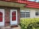 Inviting condo front door with brick accents, unit number, and well-maintained landscaping at 5865 37Th N Ave # 26, St Petersburg, FL 33710