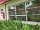 Large window with lush greenery creates a serene and private atmosphere at 5865 37Th N Ave # 26, St Petersburg, FL 33710