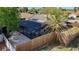 Aerial view of the screened in pool surrounded by a wooden fence and palm tree at 6682 Mauna Loa Blvd, Sarasota, FL 34241