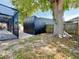 Backyard view with black storage shed and screened in porch with pavers at 6682 Mauna Loa Blvd, Sarasota, FL 34241