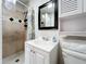Bathroom with tile shower, vanity, and framed mirror at 6682 Mauna Loa Blvd, Sarasota, FL 34241
