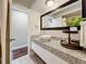 Bright bathroom featuring a modern vessel sink, granite countertop, and updated vanity at 6682 Mauna Loa Blvd, Sarasota, FL 34241