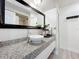 Bathroom showcasing a modern vessel sink, granite countertop, updated vanity, and a framed mirror at 6682 Mauna Loa Blvd, Sarasota, FL 34241