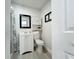 Clean bathroom with vanity, white cabinets, and a framed mirror at 6682 Mauna Loa Blvd, Sarasota, FL 34241