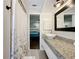 Bright bathroom featuring a vessel sink, granite counters, and neutral decor at 6682 Mauna Loa Blvd, Sarasota, FL 34241