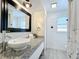 Bathroom with a vessel sink, granite countertop, framed mirror, and shiplap siding at 6682 Mauna Loa Blvd, Sarasota, FL 34241