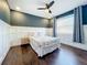Comfortable bedroom featuring a ceiling fan, stylish wall trim, and hardwood floors, creating a cozy atmosphere at 6682 Mauna Loa Blvd, Sarasota, FL 34241