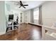Spacious bedroom with wood floors, ceiling fan, and en-suite bathroom at 6682 Mauna Loa Blvd, Sarasota, FL 34241
