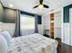 Comfortable bedroom with a ceiling fan, closet with built-in shelving and window views at 6682 Mauna Loa Blvd, Sarasota, FL 34241