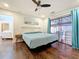 Bedroom featuring hardwood floors and sliding glass doors out to the pool at 6682 Mauna Loa Blvd, Sarasota, FL 34241