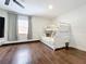 Bright bedroom featuring a bunk bed, window, and wood floors at 6682 Mauna Loa Blvd, Sarasota, FL 34241