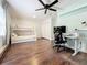 This bedroom features a bunk bed, desk, ceiling fan, and wood floors at 6682 Mauna Loa Blvd, Sarasota, FL 34241