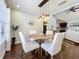 Charming dining area with wood floors, open to a stone fireplace and bright living space at 6682 Mauna Loa Blvd, Sarasota, FL 34241