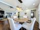 Cozy dining space with modern lighting fixture, open concept living, and backyard pool views at 6682 Mauna Loa Blvd, Sarasota, FL 34241