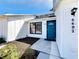 Inviting home featuring a vibrant blue front door and beautifully landscaped entryway at 6682 Mauna Loa Blvd, Sarasota, FL 34241
