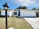 Charming single-story home boasts a well-manicured lawn and updated exterior at 6682 Mauna Loa Blvd, Sarasota, FL 34241