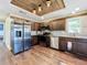 Kitchen boasting stainless steel appliances, wooden cabinets, and hardwood flooring at 6682 Mauna Loa Blvd, Sarasota, FL 34241