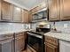 Close-up of kitchen with stainless steel appliances, granite countertops, and ample cabinet space at 6682 Mauna Loa Blvd, Sarasota, FL 34241