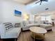 Spacious living room with vaulted ceilings, a cozy sofa, and a jute rug at 6682 Mauna Loa Blvd, Sarasota, FL 34241