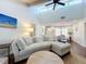 Bright living room featuring a vaulted ceiling, large sectional sofa, and wood flooring at 6682 Mauna Loa Blvd, Sarasota, FL 34241
