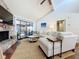 Bright living room with stone fireplace and sliding glass doors to backyard pool at 6682 Mauna Loa Blvd, Sarasota, FL 34241