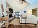 Open-concept living room features stone fireplace and seamless flow to an outdoor pool area at 6682 Mauna Loa Blvd, Sarasota, FL 34241