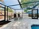 Inviting poolside patio with comfortable lounge chairs and a screened enclosure at 6682 Mauna Loa Blvd, Sarasota, FL 34241