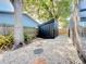 Backyard storage shed with rock landscaping and privacy fence in a well-maintained yard at 6682 Mauna Loa Blvd, Sarasota, FL 34241