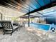 Covered swimming pool area with comfortable seating and clear blue water at 6682 Mauna Loa Blvd, Sarasota, FL 34241