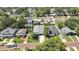 The property's aerial view features a pristine lawn, complemented by a lengthy driveway and mature landscaping, close to main street at 710 W Peninsular St, Tampa, FL 33603