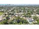 An aerial shot highlights the property's generous lot size and the surrounding lush greenery, with city views in the distance at 710 W Peninsular St, Tampa, FL 33603