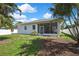 Relax on a large, screened patio overlooking a private backyard surrounded by lush tropical landscaping at 710 W Peninsular St, Tampa, FL 33603